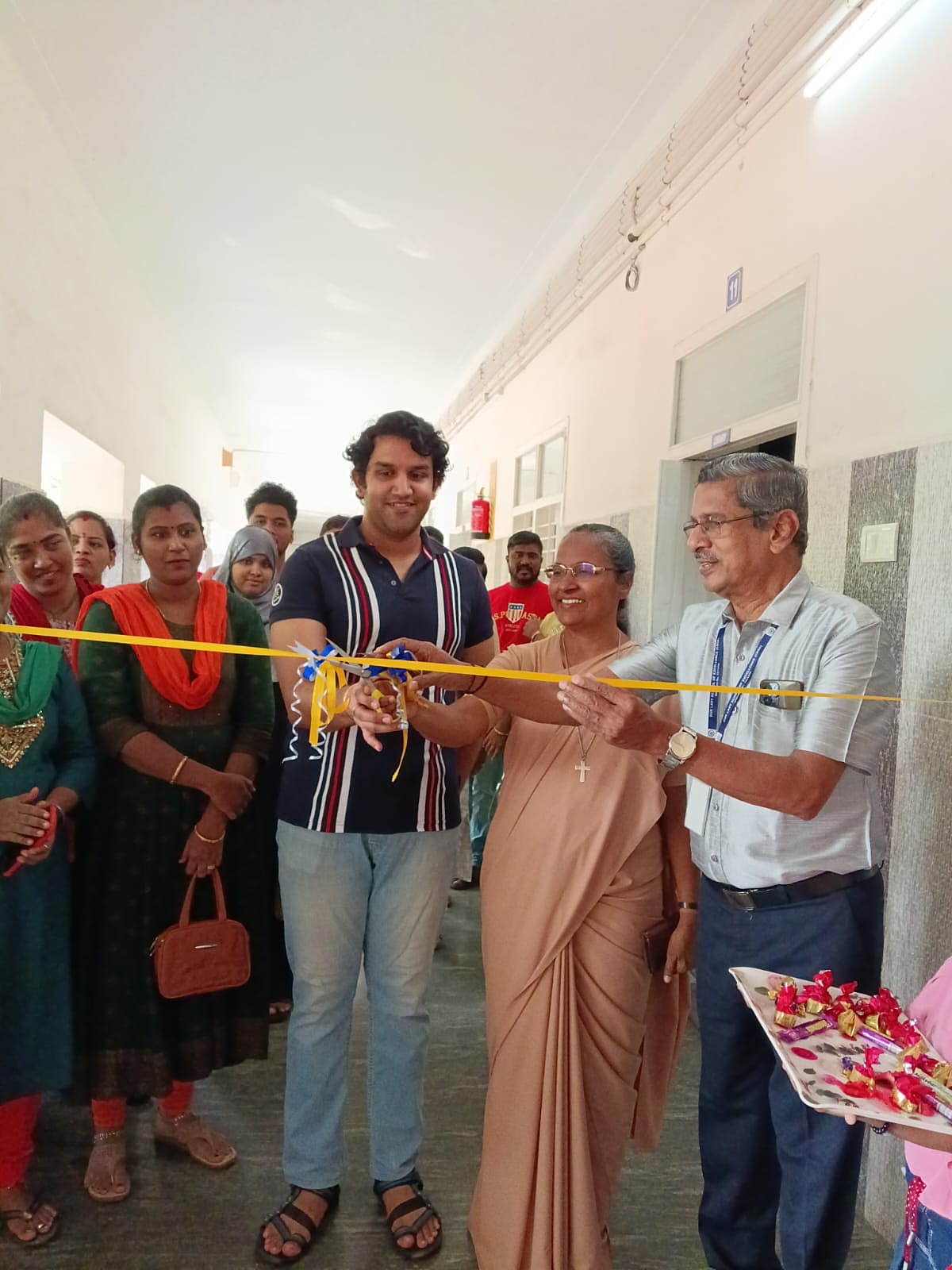 A Salesian Sister cutting the ribbon to open a new school corridor