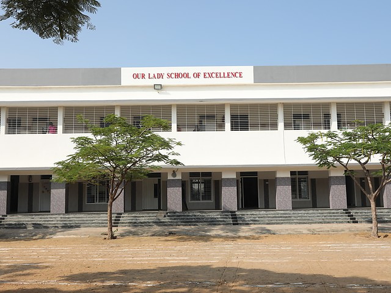 The main building, the school name above the upper storey